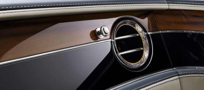 bentley-new-flying-spur-interior-front-dual-veneer-and-diamond-knurled-bullseye-vent-699x309.jpg